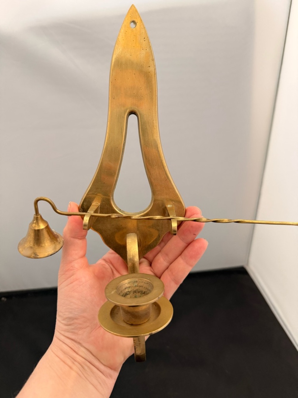 Vintage mid-century modern brass wall-mounted candle sconce with a snuffer